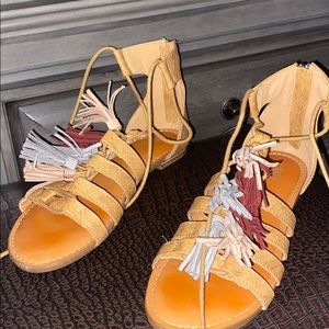 Sandals with colorful tassels. Zip up in the back